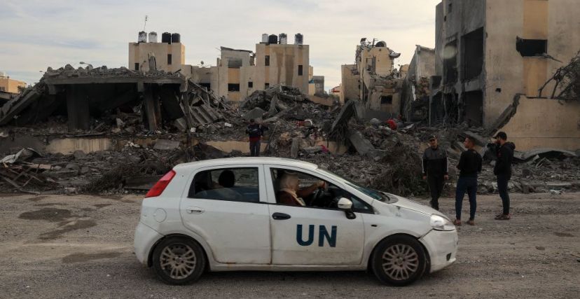 A UN car drives past the rubble of a building following Israeli strikes in Rafah in the southern Gaza Strip on November 22, 2023, amid ongoing battles between Israel and the Palestinian militant group Hamas. (Photo by SAID KHATIB / AFP) (Photo by SAID KHATIB/AFP via Getty Images)
