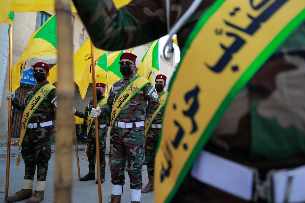 Members of the Hezbollah brigades, Kataeb Hezbollah, attend the funeral of Fadel al-Maksusi, a fighter who was also part of the "Islamic resistance in Iraq", the group that has claimed all recent attacks against US troops in Iraq and Syria, in Baghdad on November 21, 2023. According to security sources, earlier on November 21 a drone strike hit a vehicle belonging to a pro-Iran group in Iraq, killing one of its occupants. (Photo by AHMAD AL-RUBAYE / AFP) (Photo by AHMAD AL-RUBAYE/AFP via Getty Images)