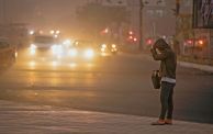 A man stands on the roadside in Baghdad as thick dust blankets the city, on March 31, 2023. - A sandstorm enveloped central Iraq, including Baghdad on March 31, the first such weather event to hit the arid country this year, after it experienced in 2022 an unprecedented number of sandstorms, which was attributed to desertification. (Photo by Murtadha Ridha / AFP) (Photo by MURTADHA RIDHA/AFP via Getty Images)