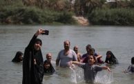 KARBALA, IRAQ - SEPTEMBER 01: People participating in the Arbain march cool off at the Euphrates river during hot weather in Karbala, Iraq on September 01, 2023. Pilgrims from different cities marched on the 40th day of Ashura to commemorate the killing of Imam Hussein, the grandson of the Prophet Muhammad, and 72 people with him in the seventh century. (Photo by Karar Essa/Anadolu Agency via Getty Images)