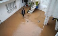 TOPSHOT - A man walks in a flooded courtyard following heavy rains in Dohuk in Iraq's northern autonomous Kurdistan region on March 19, 2024. (Photo by Ismael ADNAN / AFP) (Photo by ISMAEL ADNAN/AFP via Getty Images)