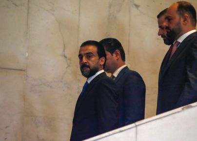 Iraqi Parliament Speaker Muhammad al-Halbousi (L) arrives at the parliament ahead of a confidence vote on a new government, on October 27, 2022. - Prime minister-designate Mohammed Shia al-Sudani was chosen earlier in October to form a new government following months of infighting between key Shiite Muslim factions. (Photo by Ahmad Al-rubaye / AFP) (Photo by AHMAD AL-RUBAYE/AFP via Getty Images)