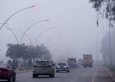 MOSUL, IRAQ - JANUARY 03: Vehicles are seen on their way during foggy weather in Mosul, Iraq on January 03, 2024. (Photo by Ismael Adnan Yaqoob/Anadolu via Getty Images)