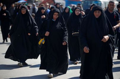 Shiite Muslim pilgrims march from the centre of Baghdad towards its northern district of Kadhimiya on February 13, 2023 to commemorate the anniversary of Imam Musa al-Kadhim's death in the 8th century AD. (Photo by AHMAD AL-RUBAYE / AFP) (Photo by AHMAD AL-RUBAYE/AFP via Getty Images)