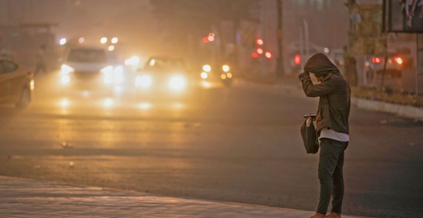 A man stands on the roadside in Baghdad as thick dust blankets the city, on March 31, 2023. - A sandstorm enveloped central Iraq, including Baghdad on March 31, the first such weather event to hit the arid country this year, after it experienced in 2022 an unprecedented number of sandstorms, which was attributed to desertification. (Photo by Murtadha Ridha / AFP) (Photo by MURTADHA RIDHA/AFP via Getty Images)