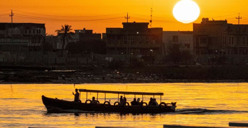 TOPSHOT - A leisure boat cruises in the Shatt al-Arab waterway, formed at the confluence of the Tigris and Euphrates rivers, at sunset in Iraq's southern city of Basra during the Muslim holy month of Ramadan on April 14, 2023. (Photo by Hussein Faleh / AFP) (Photo by HUSSEIN FALEH/AFP via Getty Images)