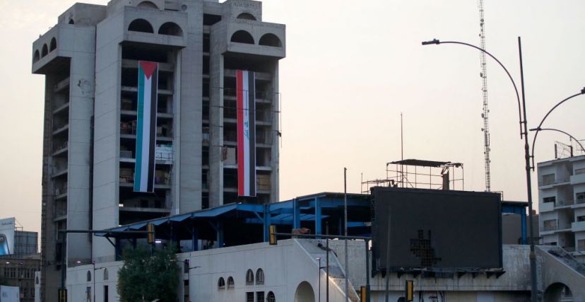 The Palestinian (L) and Iraqi flags are hung on the building of the Turkish Restaurant in Baghdad on October 12, 2023, to express support for the Palestinians as fighting rages between Israel and the Hamas movement for the sixth consecutive day. In towns across the Arab world, pro-Palestinian sentiment has surged after a shock Hamas attack on Israel, sparking a groundswell of solidarity for the Palestinians. (Photo by Ahmad AL-RUBAYE / AFP) (Photo by AHMAD AL-RUBAYE/AFP via Getty Images)