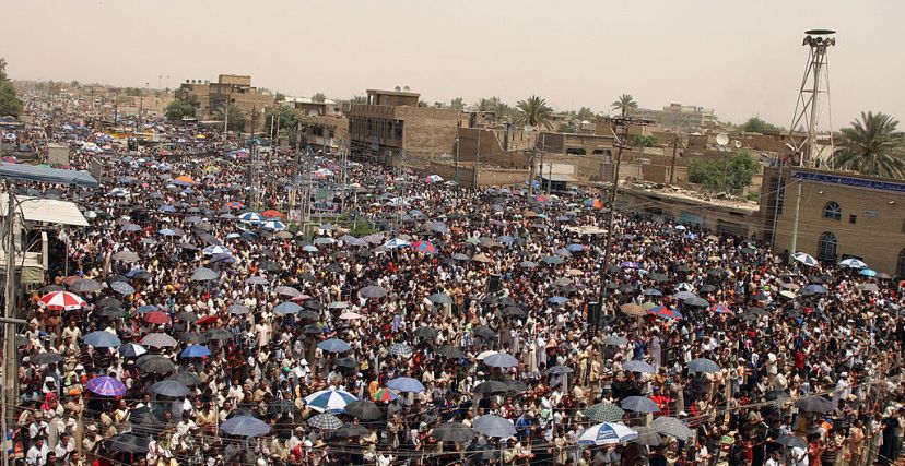 Iraqi Shiites gather to perform the Friday noon prayer organised by hardline Moqtada al-Sadr's supporters in Baghdad's Sadr City on May 02, 2008. Shiite militiamen, mainly from Sadr's Mahdi Army, have fought fierce street battles with US and Iraqi forces since late March in Baghdad's Sadr City, the cleric's bastion in the capital. AFP PHOTO/PATRICK BAZ (Photo credit should read PATRICK BAZ/AFP via Getty Images)
